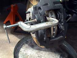 C-clamp on caliper pistons